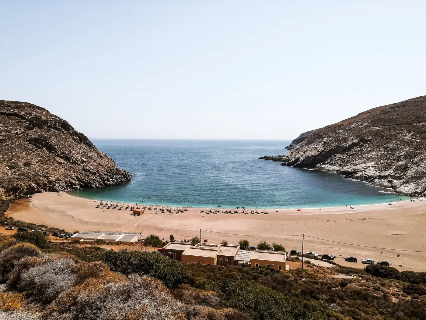 Quiet sandy cove and blue water on the island of Andros