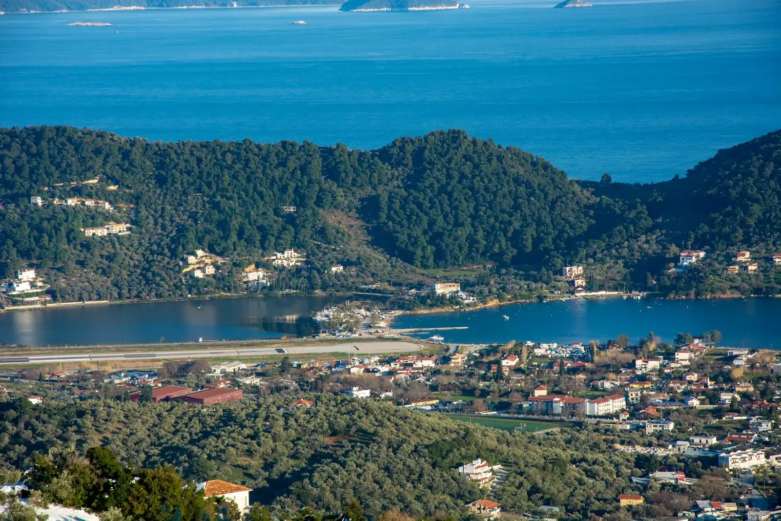 Aerial view of the green Skiathos coastline and clear Aegean water